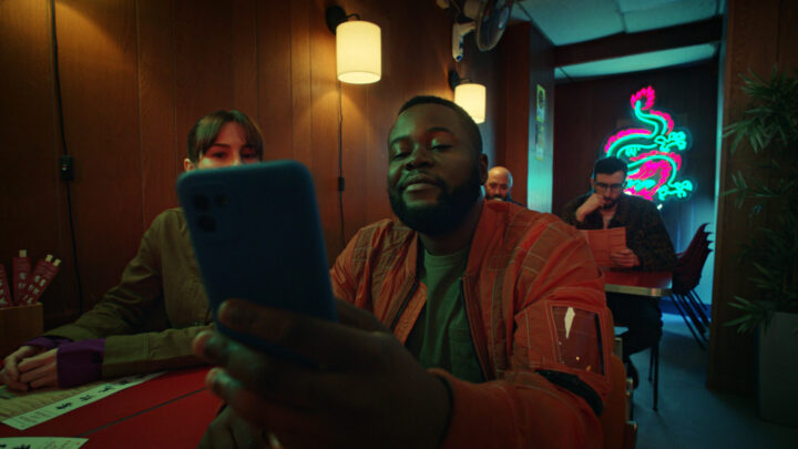 Man looking at his phone smuggly