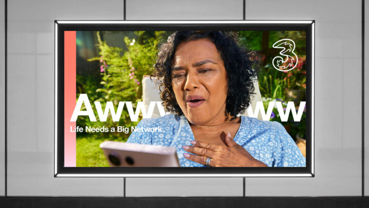 Carol looks at phone text in white behind her reads Awwwww