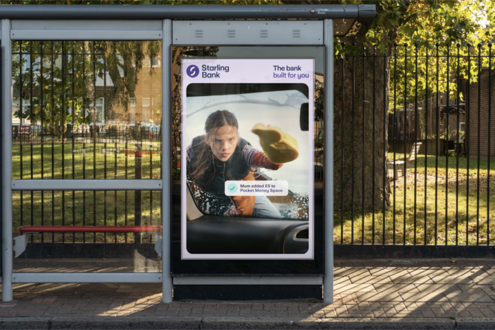 Girl washing car wind screen on billboard